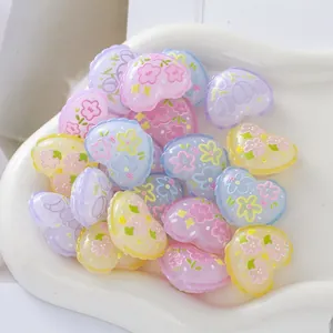 Macro view of pastel relief heart beads with floral print for DIY jewelry crafts