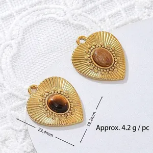 Detailed macro view of heart-shaped tiger eye stone pendant with 18K gold plated finish