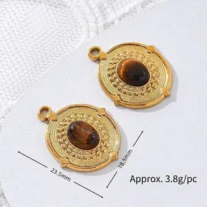 Detailed view of oval tiger eye stone pendant with gold plated stainless steel frame