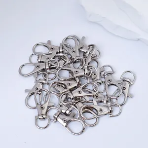 Detailed macro view of multiple silver alloy lobster clasps for DIY keychain making