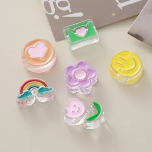 Close-up of colorful acrylic beads in heart, flower, and rainbow shapes for DIY jewelry.