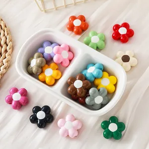 Colorful acrylic sunflower beads for DIY jewelry making in a white ceramic dish