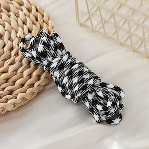 Detailed close-up view of 5mm black and white houndstooth pattern paracord for DIY crafts