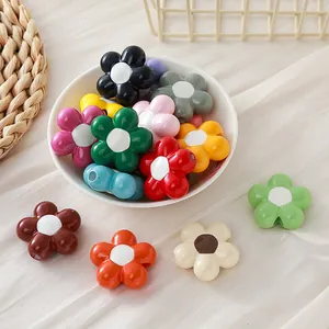 Detailed view of colorful lacquer-finish sunflower acrylic beads for DIY jewelry making.