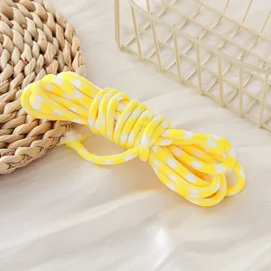 Detailed view of yellow and white houndstooth 5mm paracord cord for DIY lanyards