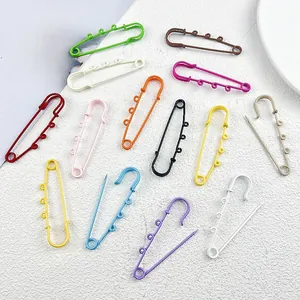 Macro view of colorful baked paint safety pins for DIY jewelry and bag accessories