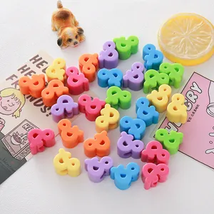 Close-up detail of colorful candy-toned acrylic ampersand beads for DIY craft jewelry
