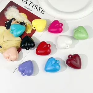 Close-up of colorful acrylic heart charms with hanging holes for DIY jewelry making