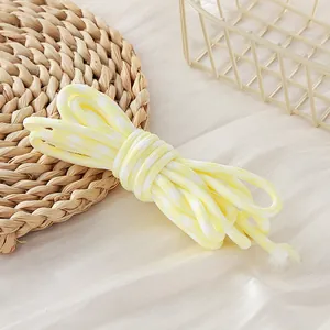 Close-up detail of yellow and white houndstooth paracord with 5mm braided texture for DIY crafts