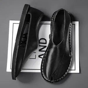 Detailed macro view showing the textured black leather and handmade stitching of these hollow sandals
