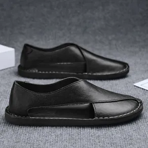 Detail of black handmade slip-on shoes with hollow side and textured leather finish