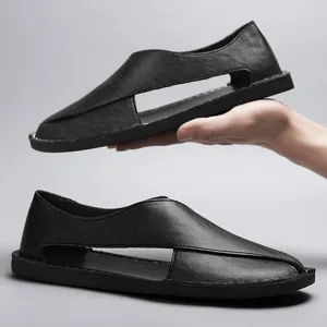Detailed side view of black vintage hollow-out leather sandals with handmade stitching.