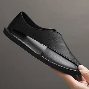 Close-up of black handmade leather hollow loafers with side cutouts for summer