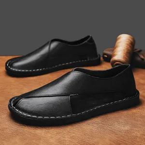 Close-up of black handmade leather loafers with breathable hollow design and stitching.