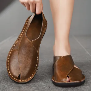 Close-up of brown retro handmade leather sandals with hollow out design and stitching details