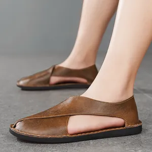 Side view detail of men's brown leather hollow-out sandals with a flat soft sole