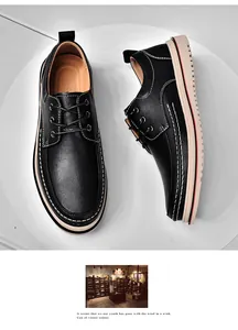 Top-down view of black men's leather derby shoes with white contrast stitching detail