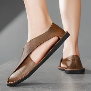 Close-up detail of brown retro leather cut-out sandals for men with flat soft soles.