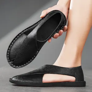 Detail of men's black handmade leather loafers with side cutout and soft flat sole