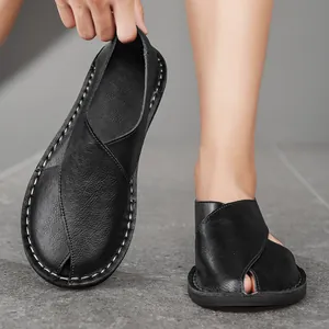 Close-up of handmade soft-sole black leather loafers with unique hollow-out design