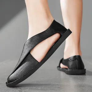 Close-up view of black handmade leather casual sandals with side-cut hollow design.