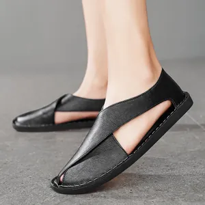 Detailed side view of black handmade hollow out leather sandals with soft flat soles