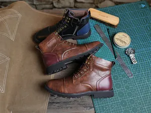 Detailed view of British style men's Martin boots in black and brown leather.