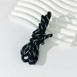 Macro detail view of 5mm black and white woven polyester rope for DIY craft accessories