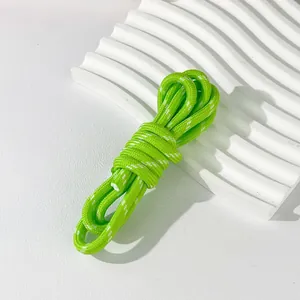 Close-up detail view of 5mm neon green and white woven paracord rope for DIY craft accessories