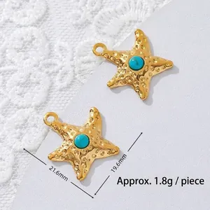 Macro detail of starfish turquoise pendant in 18K gold plated stainless steel showing size