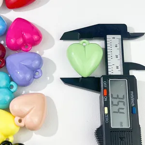 Detail view of 35.4mm colorful acrylic heart pendant measured with digital caliper.