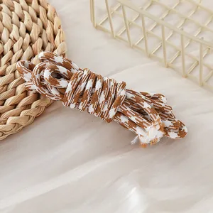 Detailed close-up view of a 5mm brown and white houndstooth patterned woven paracord