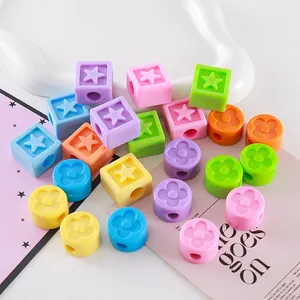Detailed macro view of colorful acrylic star and clover beads for DIY jewelry crafting