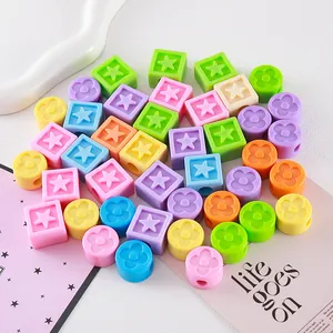 Close-up of colorful acrylic clover and star beads for DIY jewelry and keychain making.
