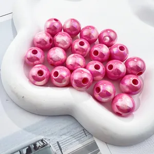 High quality detail of iridescent pink acrylic round beads with 3mm holes in tray
