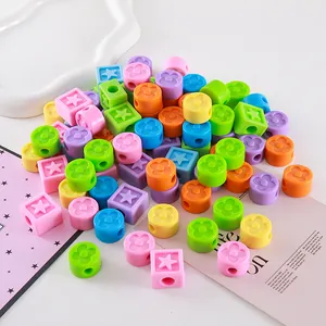 Macro view of colorful acrylic clover round and star cube beads for DIY crafts