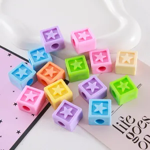 Macro view of colorful acrylic cube beads with embossed star pattern for DIY jewelry making