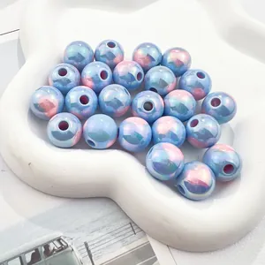 Close-up of 3mm holographic blue and pink acrylic beads for DIY jewelry making.