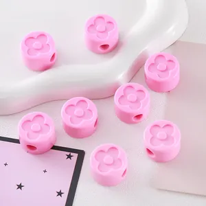 Detailed macro view of pink acrylic clover beads for DIY jewelry and keychain making