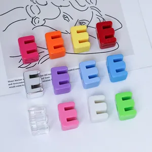 Detailed macro view of multi-colored 6mm acrylic letter E beads for DIY jewelry chains