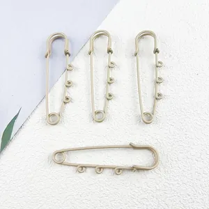 Set of large matte beige safety pins with loops for DIY keychain and jewelry crafting