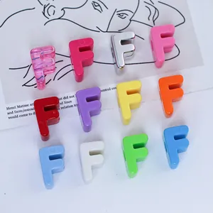 Close-up detail of colorful 6mm acrylic letter F beads for DIY keychain and phone chain making.