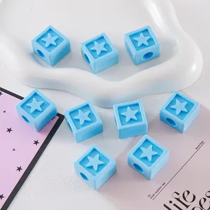 Close-up of light blue star engraved square beads for DIY keychains and crafts