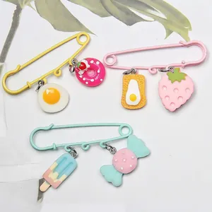 Large colorful safety pins with cute food charms for DIY clothing and bag decoration.