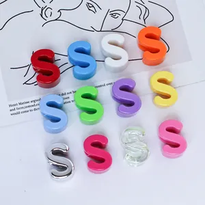Close-up of colorful 6mm acrylic S-shaped beads for DIY phone chains and charms.