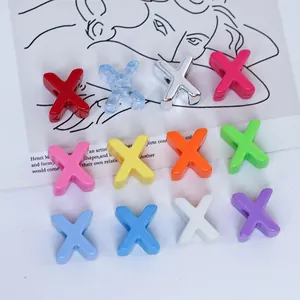 Detail view of colorful 6mm acrylic X-shaped alphabet beads for DIY jewelry