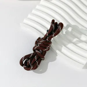 Detail of a 5mm brown and white braided cord for DIY bag and phone straps.