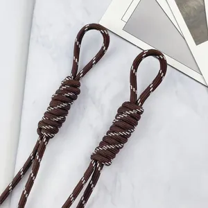 Close-up of 5mm brown braided lanyard with white accents and secure knot detail.