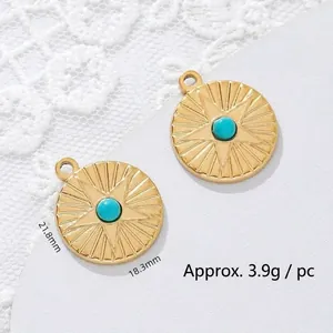 Close-up of 18K gold plated stainless steel star pendant with turquoise bead