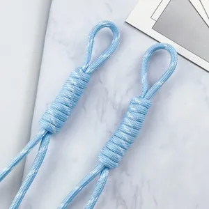 Macro detail of hand-woven light blue polyester lanyard with reinforced braided loop